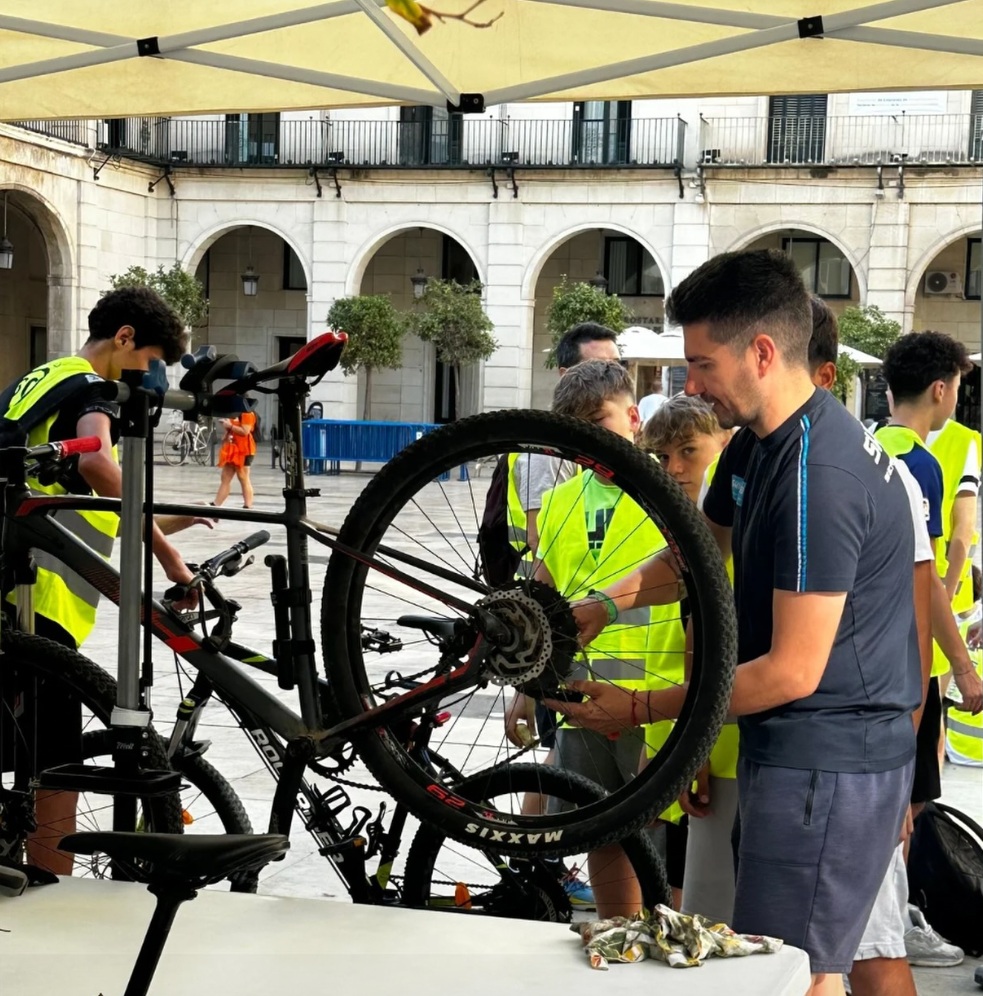 Taller de revisión y ajuste de bicicletas con mecánico y jóvenes participantes